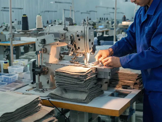 Specialized industrial sewing workstation for layered material